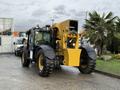 A 2014 Caterpillar TL1055C telehandler with a yellow and black exterior features large tires and a lifting arm in the foreground