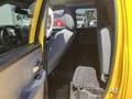Interior of a 2015 RAM 1500 showing rear seating area with grey upholstery and storage compartment on the floor