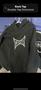 A black hoodie with a white "TAPOUT" logo on the front placed on a hanger