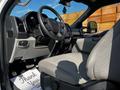 Interior view of a 2021 Ford F-550 showing steering wheel dashboard and driver's seat with gray upholstery