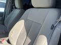 A 2013 Ford Expedition with beige upholstery showing wear and a small tear on the driver's seat