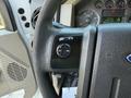 Close-up of the steering wheel of a 2009 Ford F-550 showing controls for cruise setting and activation