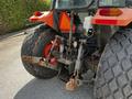 A 2011 Kubota M8540D tractor with large rear tires and a hydraulic lift system visible at the back
