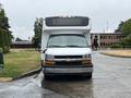 A white 2020 Chevrolet Express with a distinctive front grille and large windshield facing directly towards the viewer