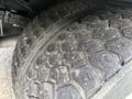 Close-up of a tire from a 2008 Ford F-450 showing tread pattern and some dirt on the surface
