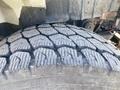 Close-up of a treaded tire from a 2014 International 7400 showcasing deep grooves and patterns for traction