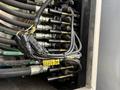 Close-up of multi-colored hydraulic hoses and connectors attached to a panel on a 2011 International WorkStar showing complex wiring and cable organization