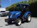 A 2018 New Holland Boomer 45 tractor in blue and black with a cab and large tires parked on a concrete surface