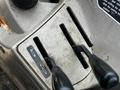 Control panel of a 2011 Kubota M8540D tractor featuring gear shift levers and markings for operation controls