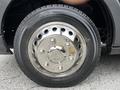 Close-up of a shiny metallic wheel rim with multiple circular cutouts and a black tire mounted on a 2017 Ford Transit 350