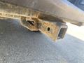 Close-up of a rusted trailer hitch attached to a 2017 Ford F-150 showing wear and dirt from use