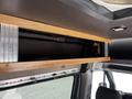 Interior storage compartment of a 2017 Mercedes-Benz Sprinter with a wooden frame and visible compartment details