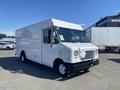 A white 2012 Ford Econoline delivery truck with a boxy shape and a flat front design parked with a for sale sign in the window