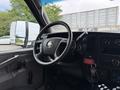 Interior view of a 2020 Chevrolet Express with a steering wheel dashboard and control panel visible