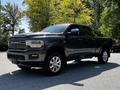 A 2022 RAM 3500 pickup truck with a metallic gray exterior and chrome accents parked slightly angled on a driveway