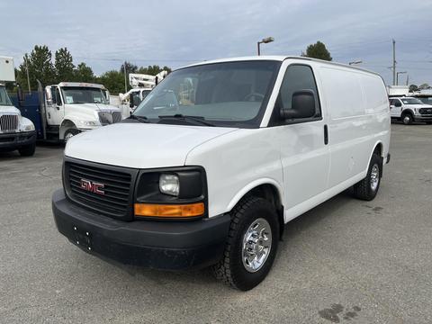 White 2012 GMC Savana cargo van with black accents and silver wheels parked at a dealership