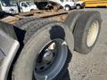 Close-up view of the rear tires and axle of a 2009 Peterbilt Highway truck with worn tread and a metallic wheel rim