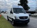 A white 2017 Mercedes-Benz Sprinter van parked on the side of the road with a simple and sleek design