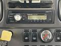 The image displays a Panasonic CQ-CX1600 car stereo unit featuring various buttons for controls and a digital display in a 2010 Freightliner M2 106 dashboard