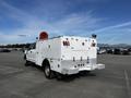 A white 2017 Ford F-350 SD with a utility body and equipment mounted on the back