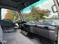 Interior of a 2007 GMC W5500 18 foot cube van featuring a driver's seat and dashboard with controls and large side mirror