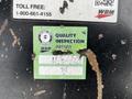 A worn green quality inspection sticker with the text "QUALITY INSPECTION PASSED" and various faded markings