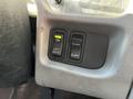 A control panel with three buttons labeled ON LIFT GATE DUMP and SUSP in a vehicle interior