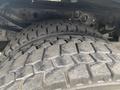 Close-up of a heavy-duty tire from a 2003 Ford F-450 SD displaying deep tread patterns and rugged texture