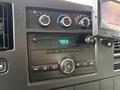 Dashboard of a 2008 Chevrolet Express showing radio controls and climate settings with digital display indicating time