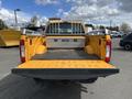 A 2017 Ford F-250 SD pickup truck with a yellow bed and a metal ladder rack in the cargo area