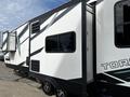 A 2022 Heartland Torque travel trailer featuring a sleek white exterior with black and teal accents and multiple windows