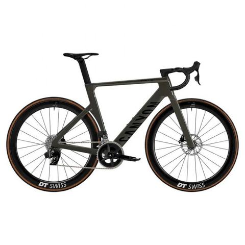 Canyon Aeroad CF SLX 7 AXS 2025 bicycle featuring a sleek frame in dark green with aero handlebars and wide tires marked DT Swiss