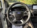 A 2019 Ford Transit Connect steering wheel with a Ford logo and control buttons visible in the foreground