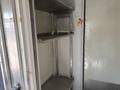 Interior shelves of a 2019 Freightliner MT45 showing metal framework with two open shelves and a clean floor space