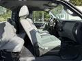 Interior view of a 2011 Ford F-250 SD showing front and rear seats with gray upholstery and a dashboard with various controls and features