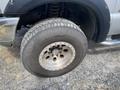 Close-up of a steel wheel and tire from a 2007 Ford F-350 SD with deep tread pattern and a six-bolt design
