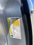 A 2014 Ford F-150 with a visible manufacturer's label displaying specifications and safety information