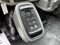 A close-up of the gear shift panel in a 2011 International 4400 featuring buttons for park reverse neutral drive and a mode selector