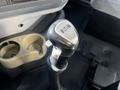 Close-up of a gear shift lever from a 2005 Volvo VND 122 with an Eaton label and a black textured grip