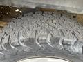 Close-up of a rugged tire with deep treads designed for off-road use showcasing its textured surface and sturdy construction