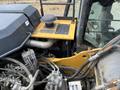 View of the engine compartment of a 2018 John Deere 350 showing various pipes wires and components with a yellow control panel on top