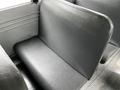 A gray bench seat inside a 2015 Spartan school bus with textured upholstery and no visible markings