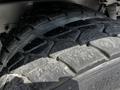 Close-up of a treaded tire from a 2010 Freightliner M2 106 showing detailed patterns and slight wear on the rubber surface