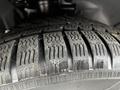 Close-up of a tire tread from a 2014 Ford Transit Connect showing detailed patterns and grooves designed for traction