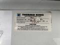 A label from a Thermo King air conditioning unit specifying refrigerant type and installation details for a vehicle