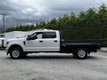 2020 Ford F-350 SD with a white cab and black flatbed parked at an angle