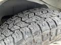 Close-up of a worn tire tread from a 2014 GMC Savana showcasing deep grooves and patterns indicating use and wear