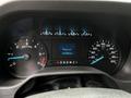 Dashboard of a 2021 Ford E-450 showing speedometer and odometer with various indicators and gauge readings