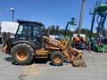 A 2008 Case Super 580M loader with a yellow and black color scheme featuring a front loader bucket and large tires