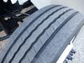 Close-up of a worn tire from a 2014 International Durastar showing visible tread patterns and wear on the rubber surface